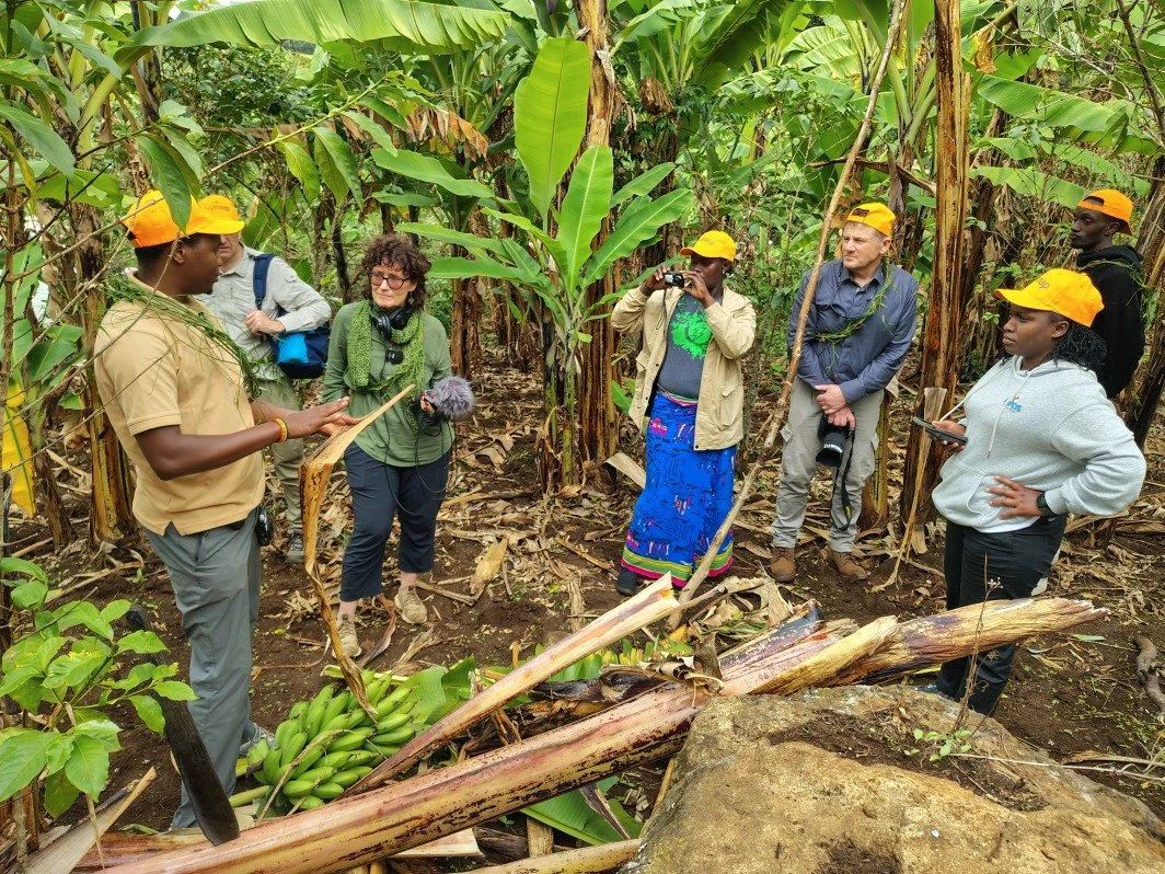 Our native guide and storyteller explaining about Matoke during a Cooking with the Kapchorwa Mamas experience in March 2026. Mount Elgon, Uganda.