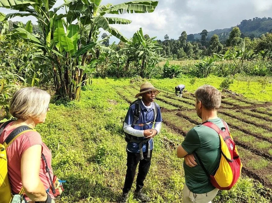 Kapchorwa Nature Walk guide Rommy giving a demo about local farming methods. Mount Elgon, Uganda.