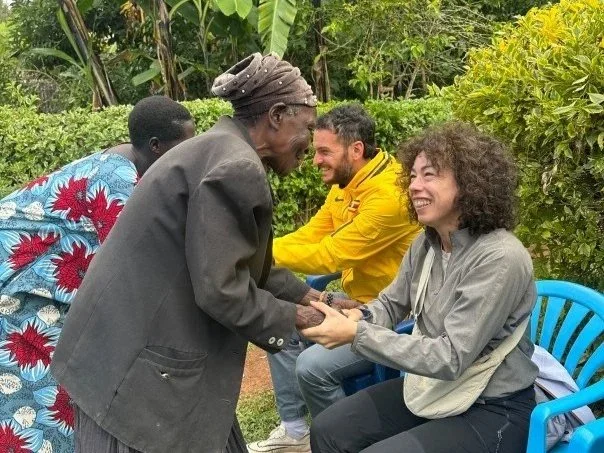 Local women welcoming guests during a cooking experience in Kapchorwa, supporting community income and cultural exchange.