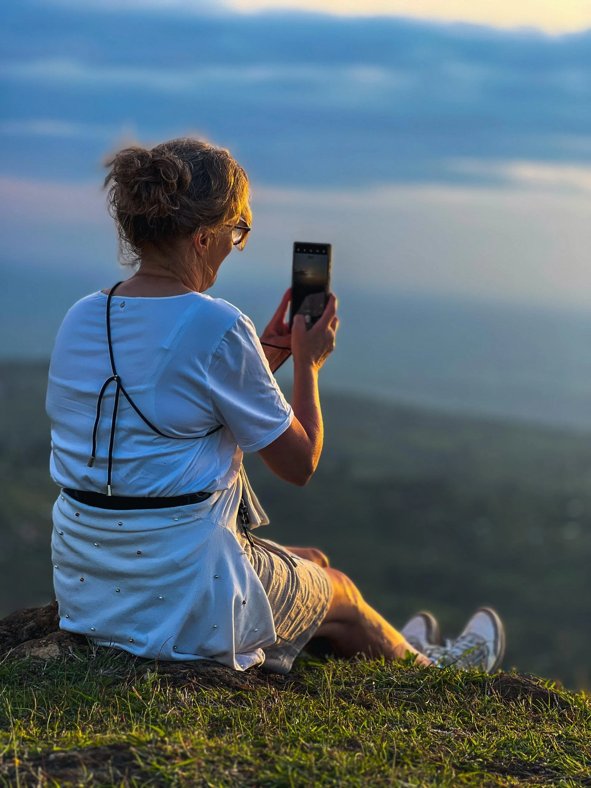 Tourist taking a photo at a beautiful viewpoint in Sipi Falls, Mount Elgon, Uganda.
