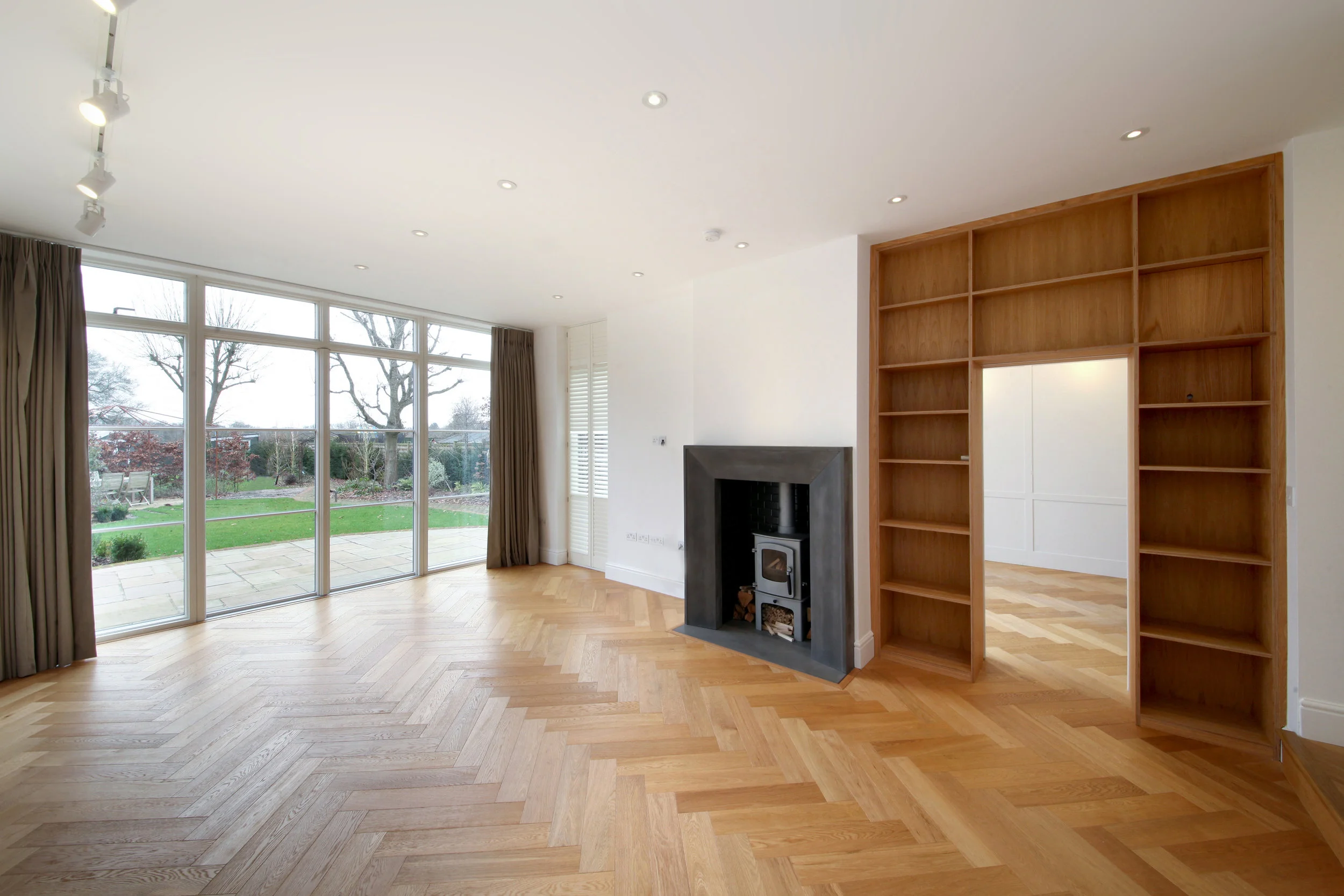  Oak veneered plywood bookcase spanning a connecting door between drawing room and dining room. Hidden within the bookcase is a sliding door. 