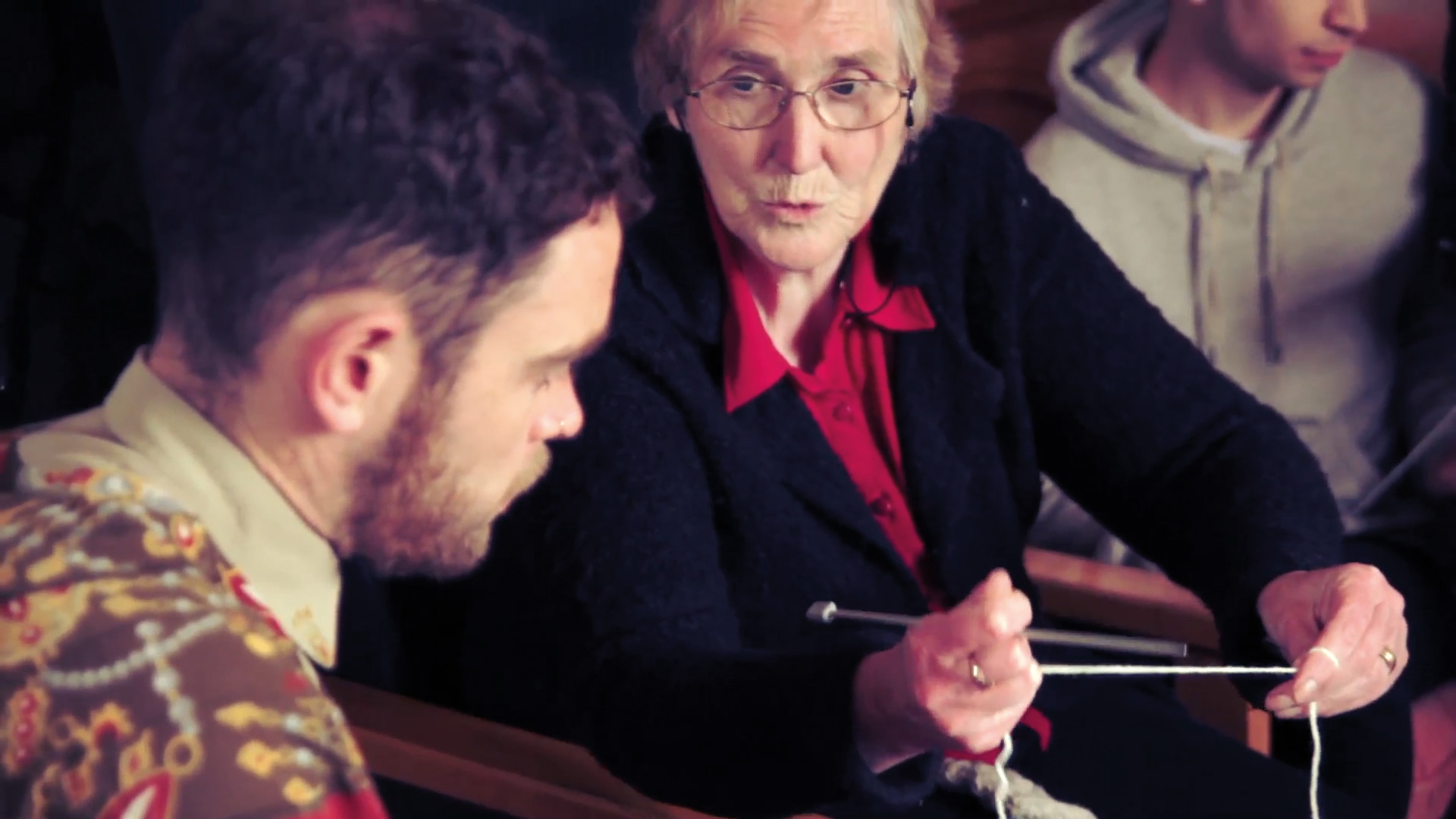 Still from Ishka Films documentation of DE14, showing Maireád Uí Fhlátharta’s knitting workshop