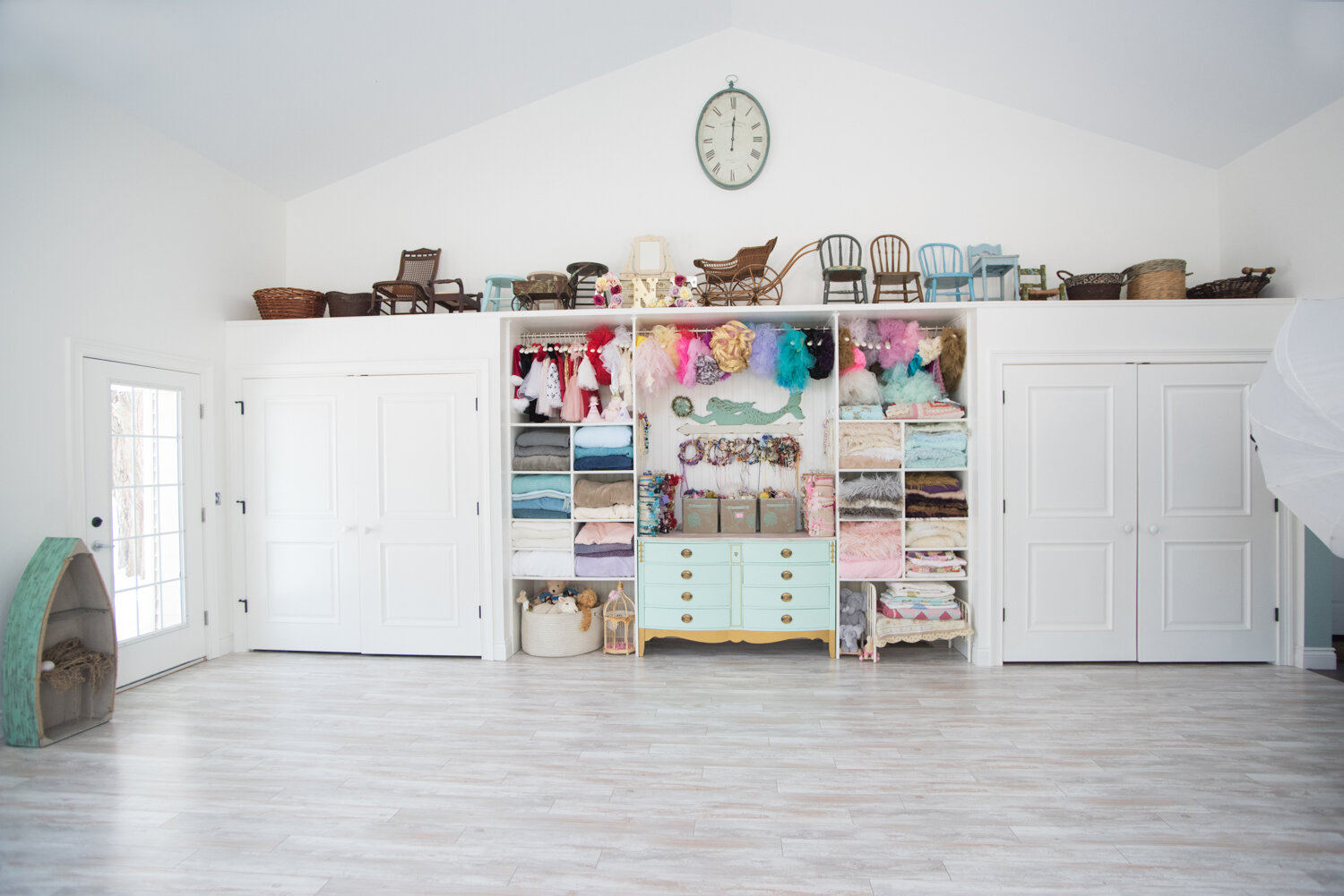   There is a whole lot more above this wall of closets and built-ins, now! The closets hold tons of adorable dresses and outfits for girls and boys, plus smaller props.  