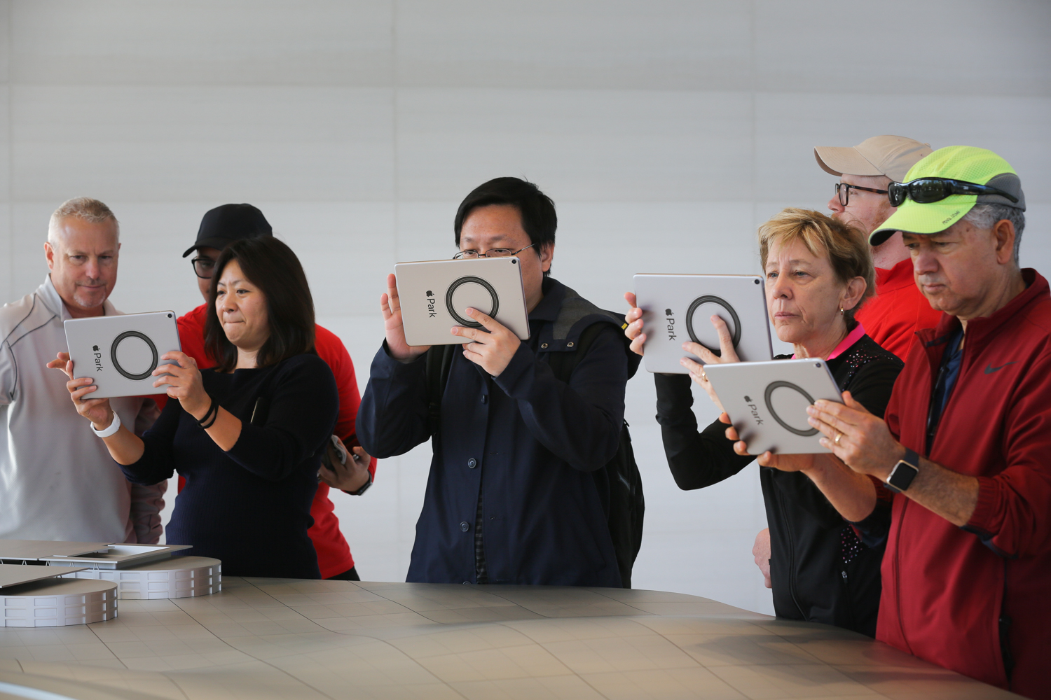  Visitors use iPads to experience an augmented reality tour of Apple's new spaceship campus at the opening of the Apple Park Visitor Center in Cupertino, California 