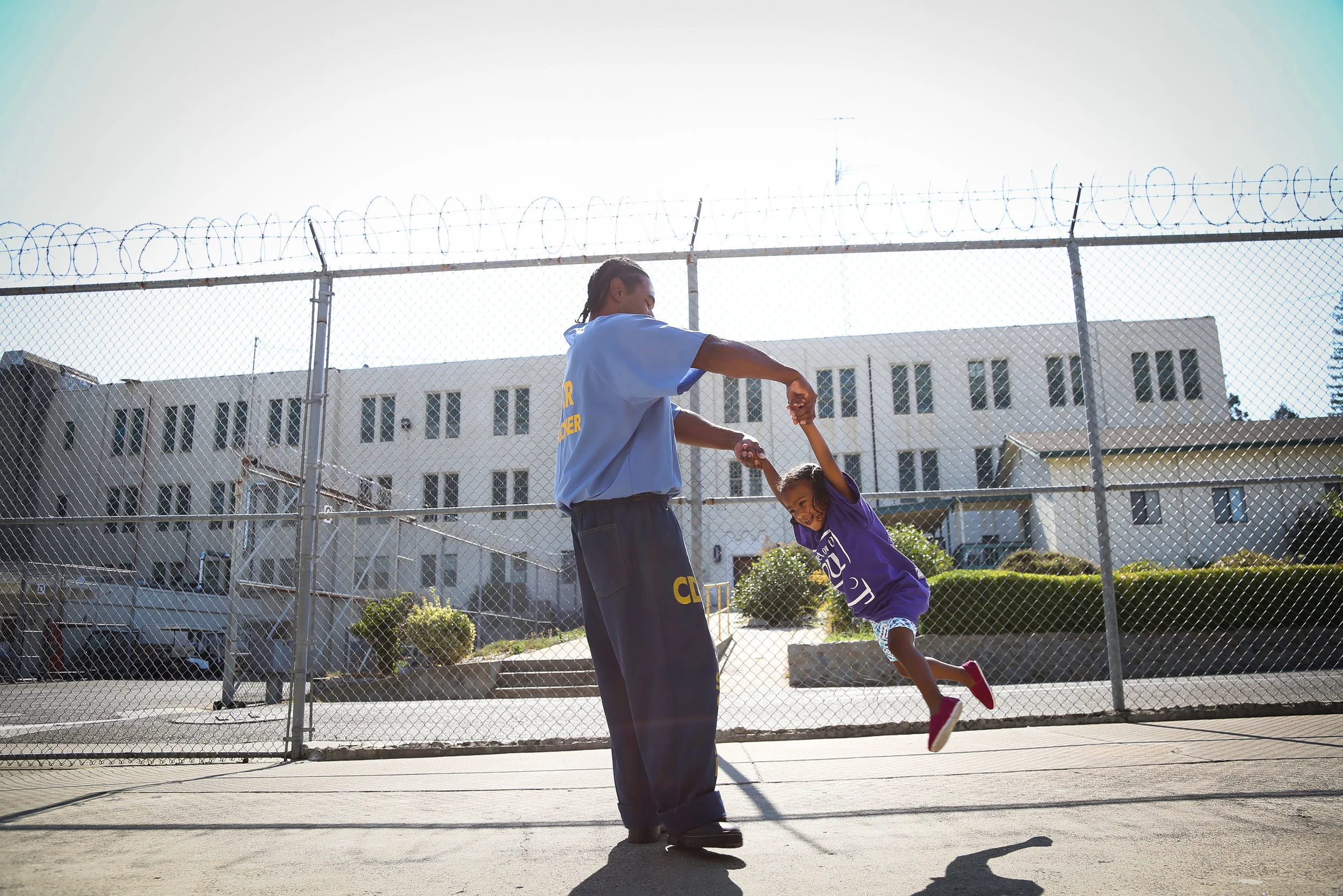 Pharaoh Haywood plays with his daughter Isis during a "Get On the Bus " visiting day to Folsom State Prison in Folsom, California