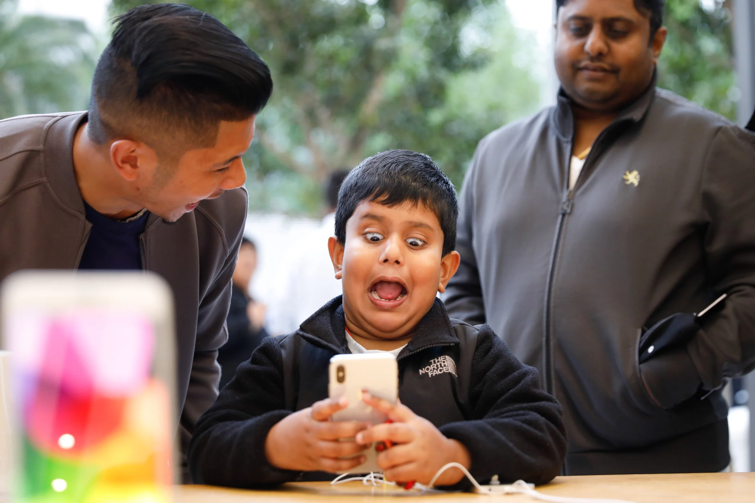 A boy uses the Animoji feature of the iPhone X on the first day of sales at the Apple Store Union Square in San Francisco, California