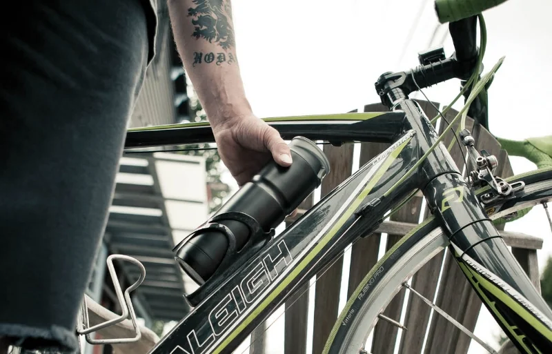 S_N13_men outdoor car bicyclers street city road tattoos bikes riding One Hand Vacuum Mug closeup water bottle cage_LIC_U_5952_MED.jpg