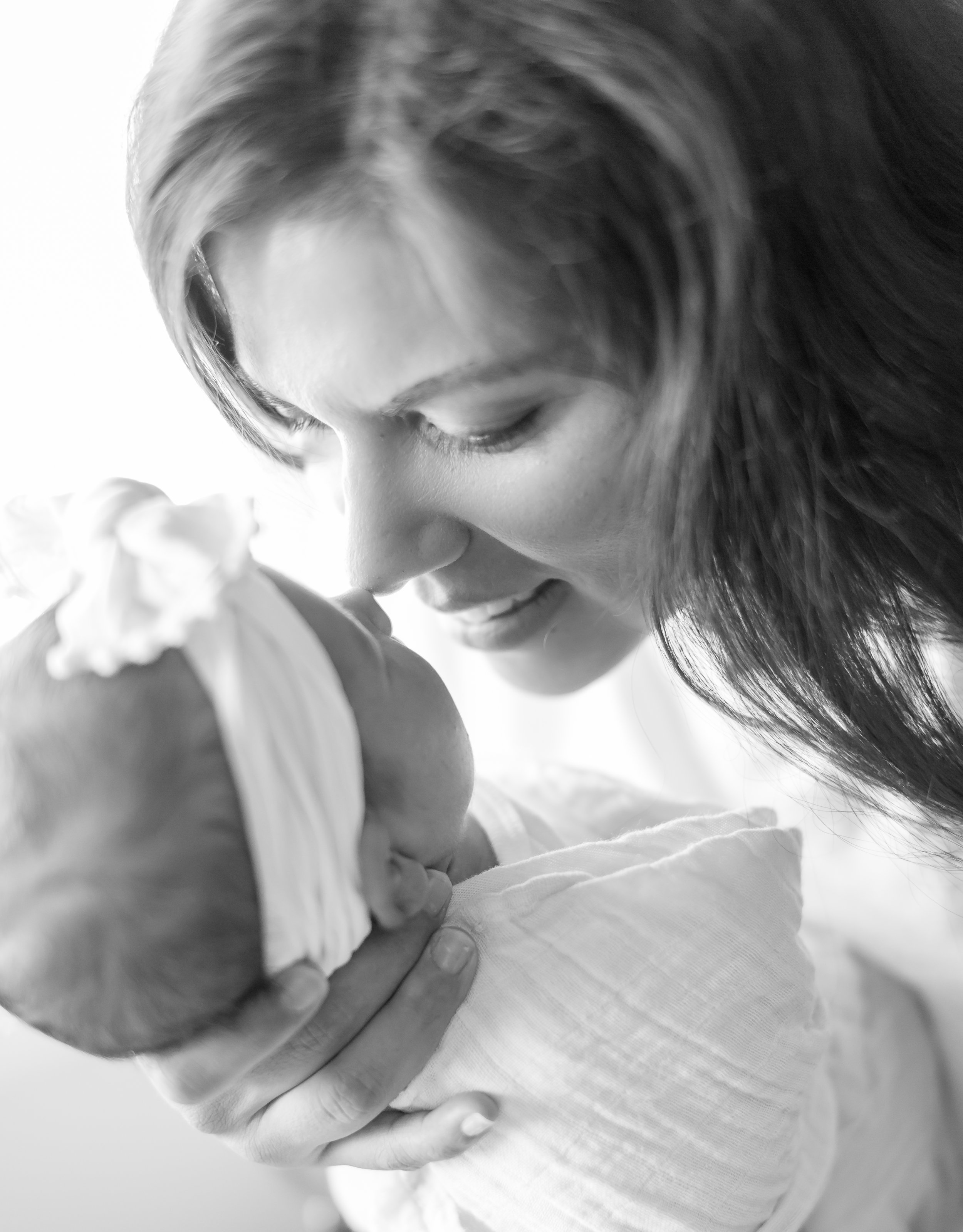 Tucson Newborn Photographer, Melissa Fritzsche Photography captures Mom and her newborn daughter nose to nose. Sweet newborn candid moments.
