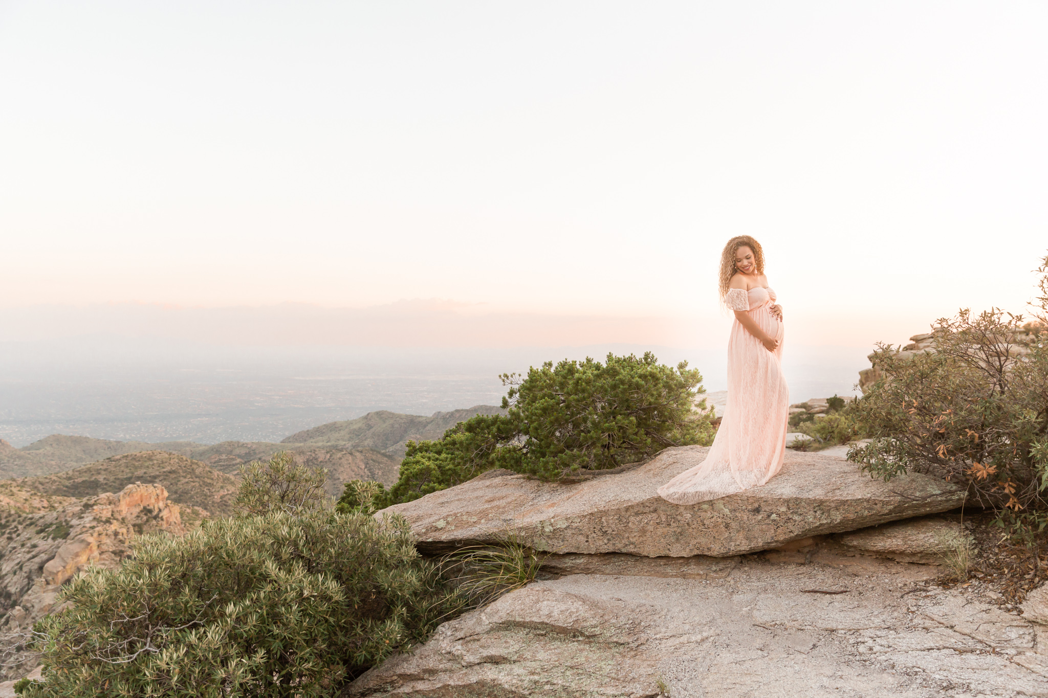 Maternity session in Tucson Arizona at Mount Lemmon. Mother-to-be wearing floor length pink off the shoulder dress. Session captured by Tucson Portrait and Wedding Photographer Melissa Fritzsche Photography.
