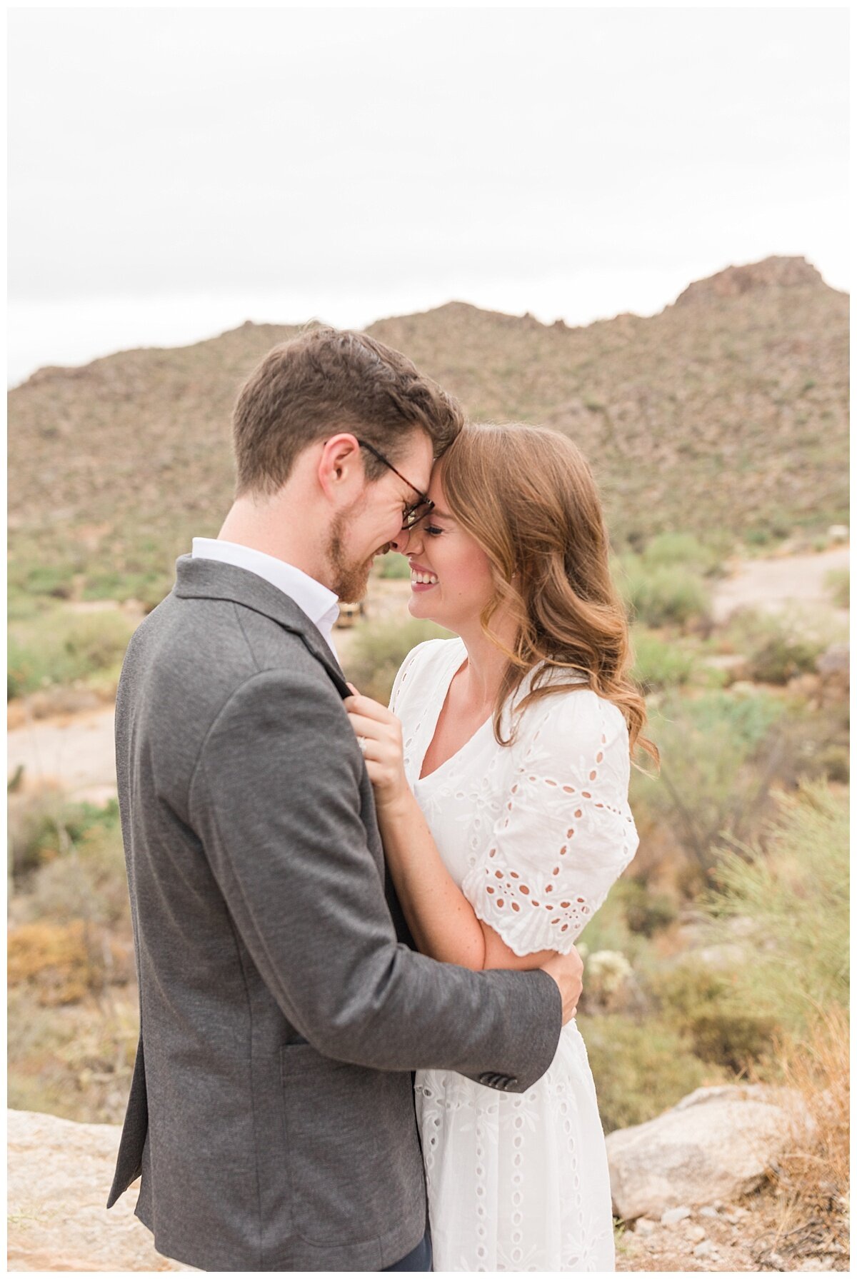 How to plan your dream desert wedding. Desert engagement session with Tucson Mountains as a backdrop.