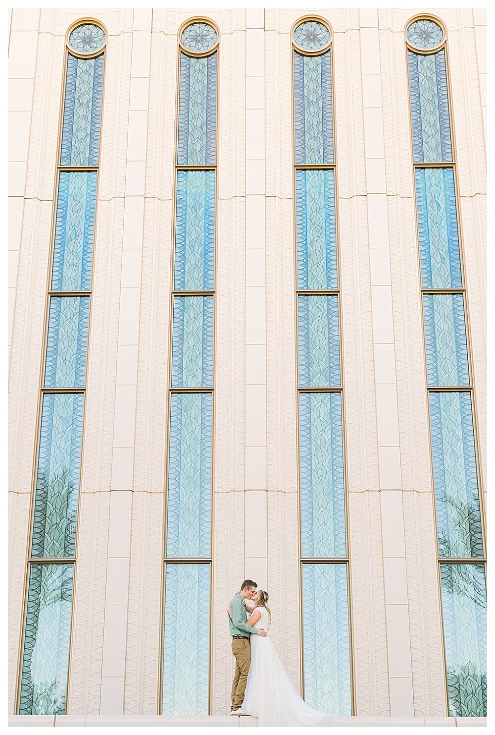 Stretching glass backdrop with couple kissing in front of the Gilber, Arizona Temple. Wedding Photography taken by Melissa Fritzsche Photography.