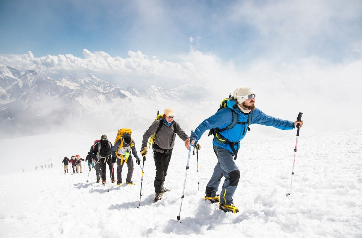 stock-photo-a-group-of-mountaineers-climbs-to-the-top-of-a-snow-capped-mountain-700077832-transformed.jpeg