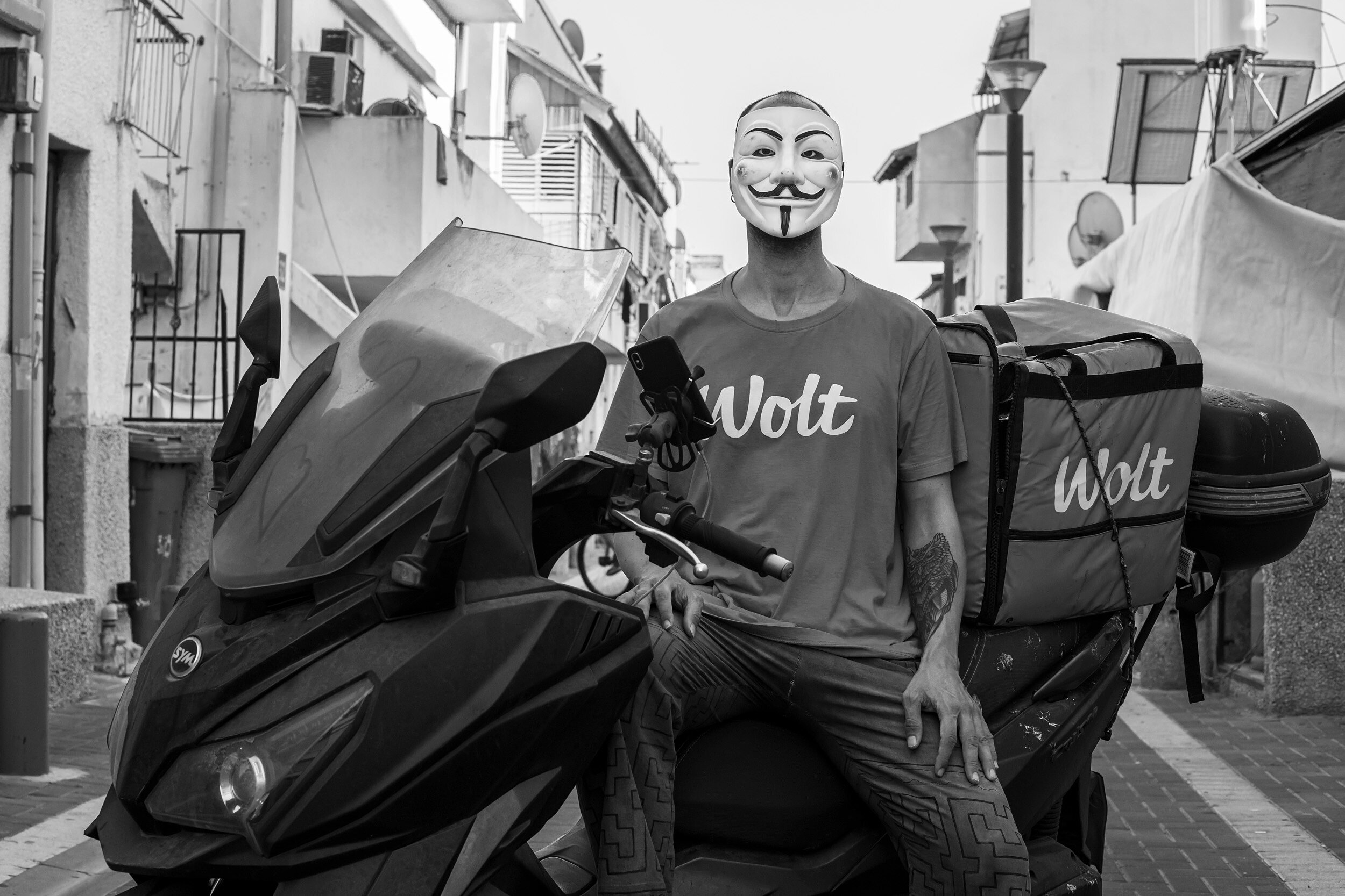 Joseph drives around with the Guy Fawkes mask regularly during his job as a food volunteer. This is his way of protesting and being identified among the social activist  