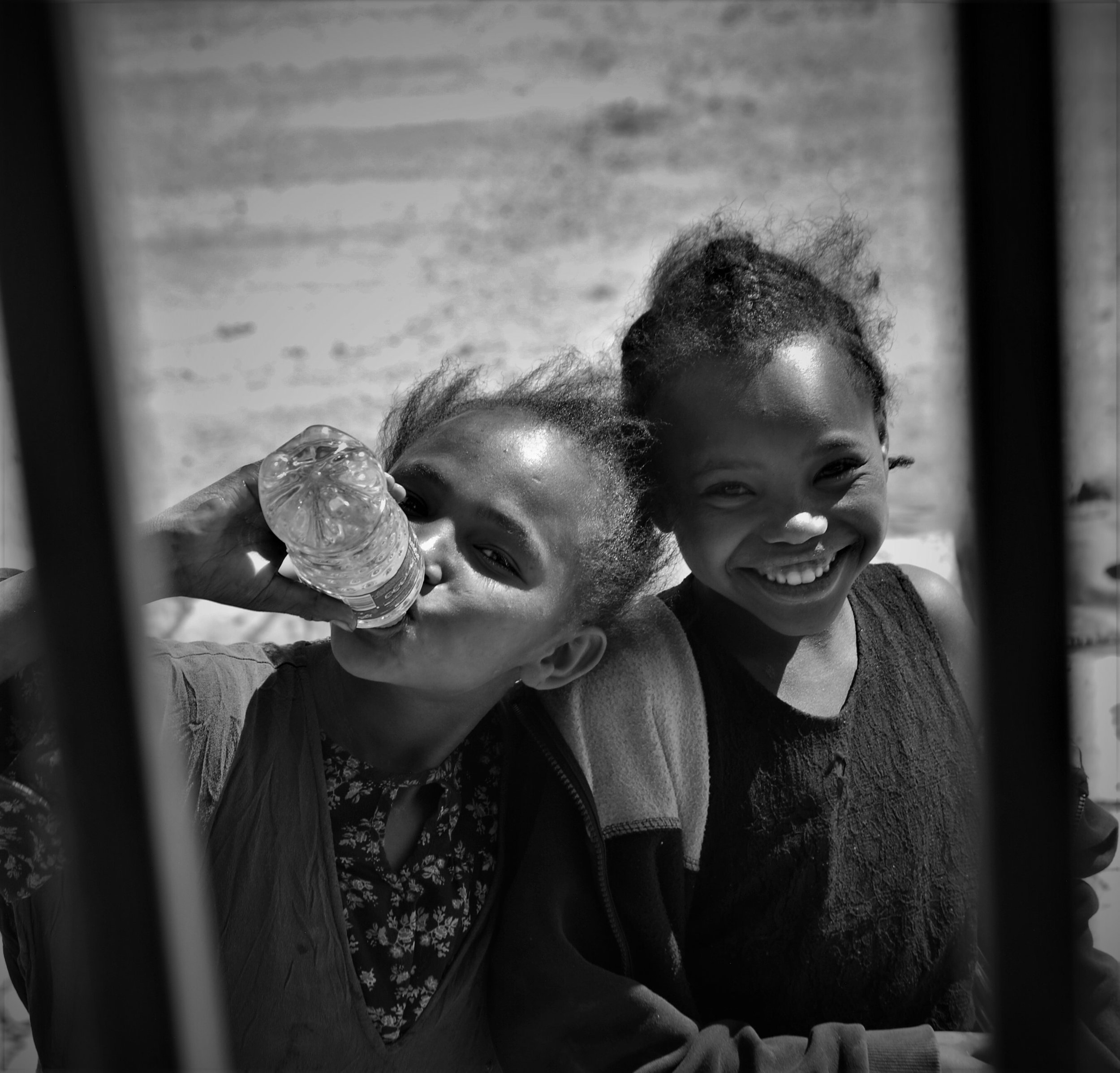  23. Two little girls laugh and smile, eyes twinkling and faces beaming with joy as they enjoy a moment of fun and happiness. 