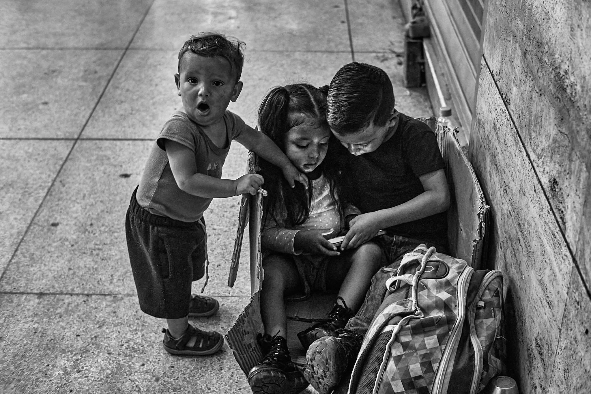 Juancho Domínguez – Here’s a striking image of three siblings, with good light and strong black-and-white. The youngest, seeming a bit left out, is alert to the camera.