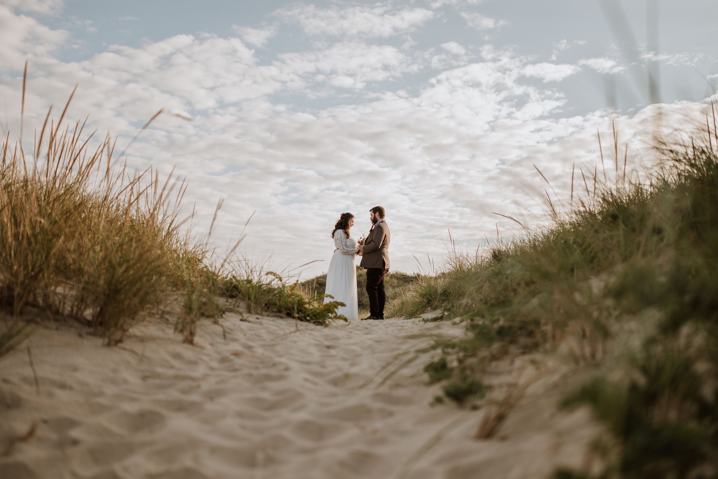 Couple exchanging vows along a sandy trail at the Cape Cod seashore.
