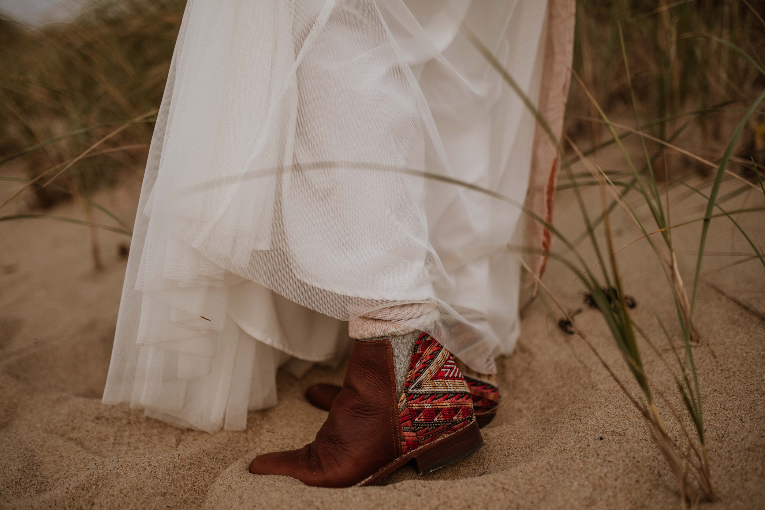 Bride's boots in the sand.