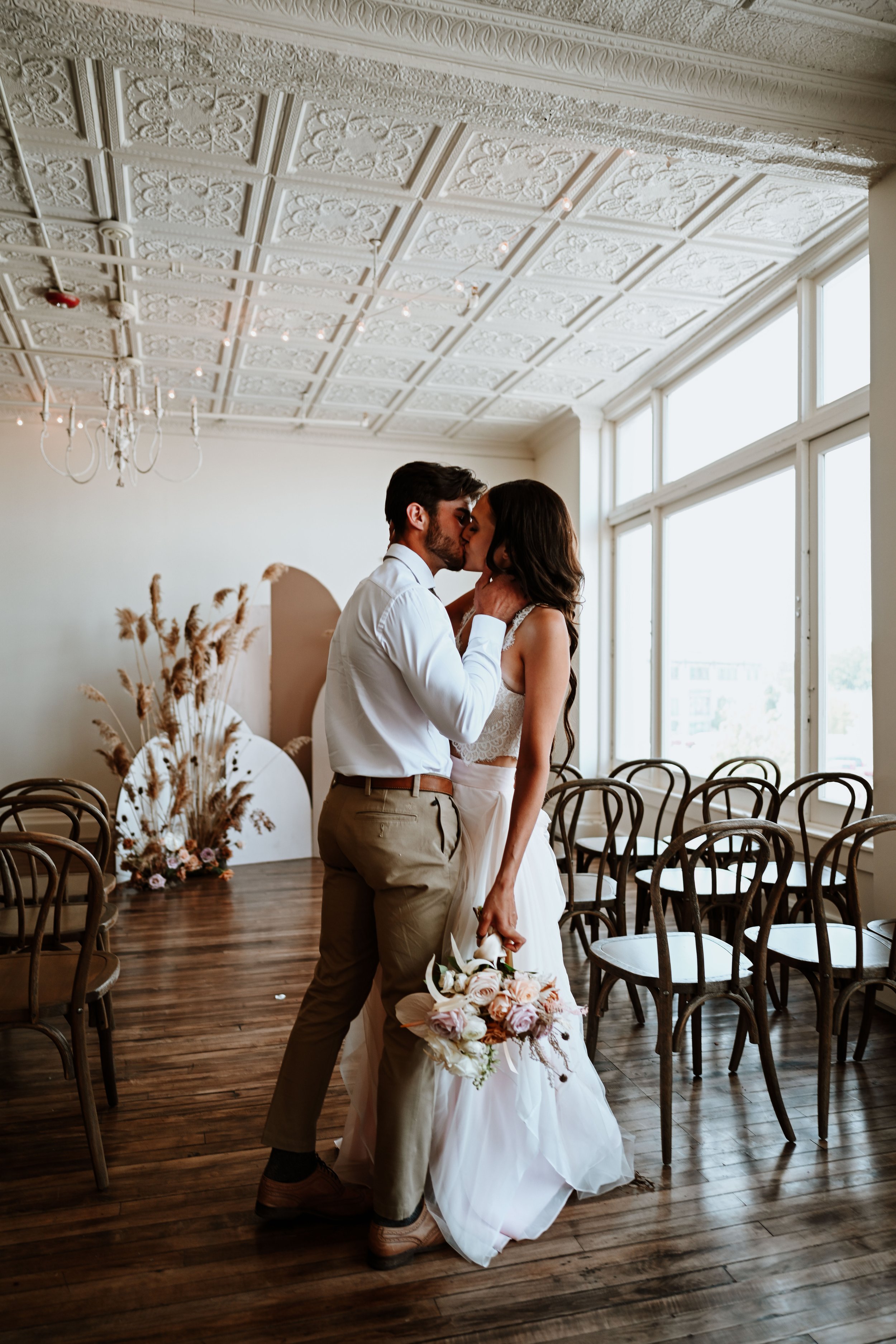 Intimate wedding featuring a couple sharing a kiss at the Lincoln Loft in Watertown, New York.