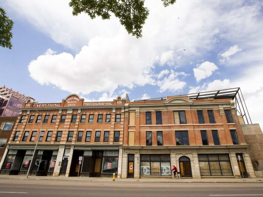 The Brighton Block, left, and the Lodge Hotel, right, shown in June 2016. Both buildings are now under wraps, literally. GREG SOUTHAM / EDMONTON JOURNAL