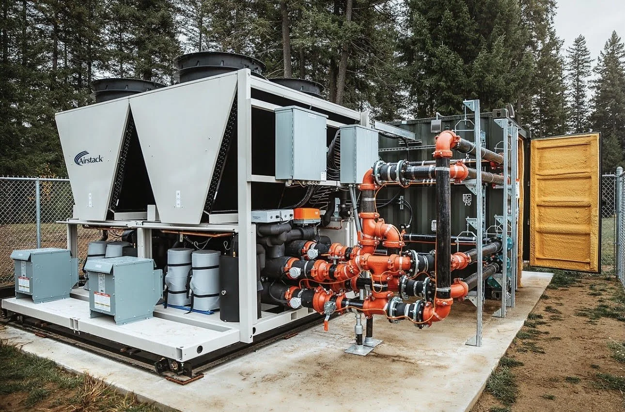 Large commercial mechanical cooling system with piping, valves, and outdoor equipment serviced by Maxwell Mechanical.