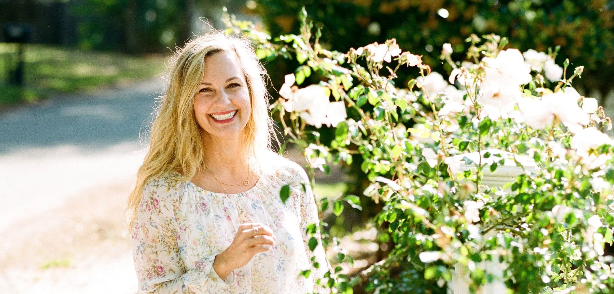 photo of honor hawkins in a garden with flowers.jpeg
