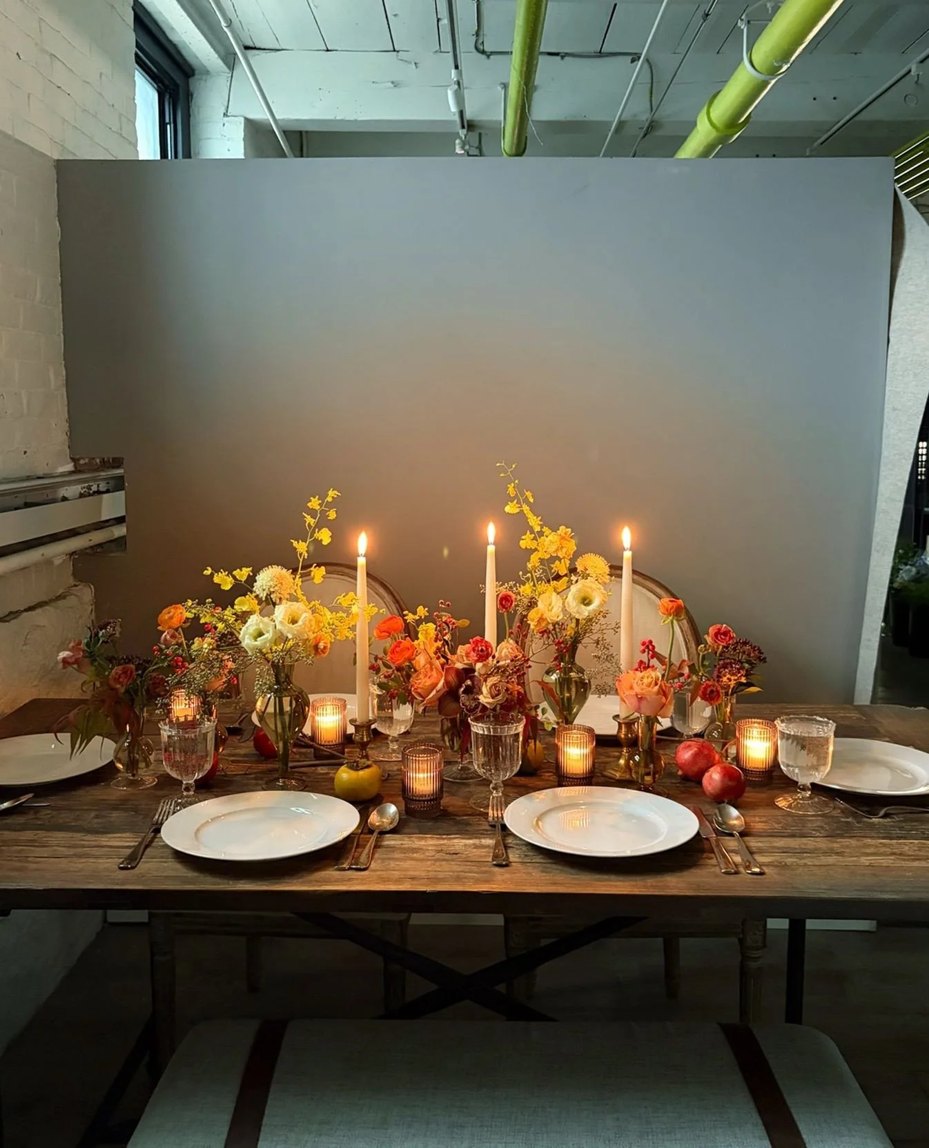 This tablescape bottle table runner design features our beautiful mixed height budvase collection of elegant seasonal colored glass. Each with a unique look, filled with hand-selected blooms and textures in complementing colorways for added depth and