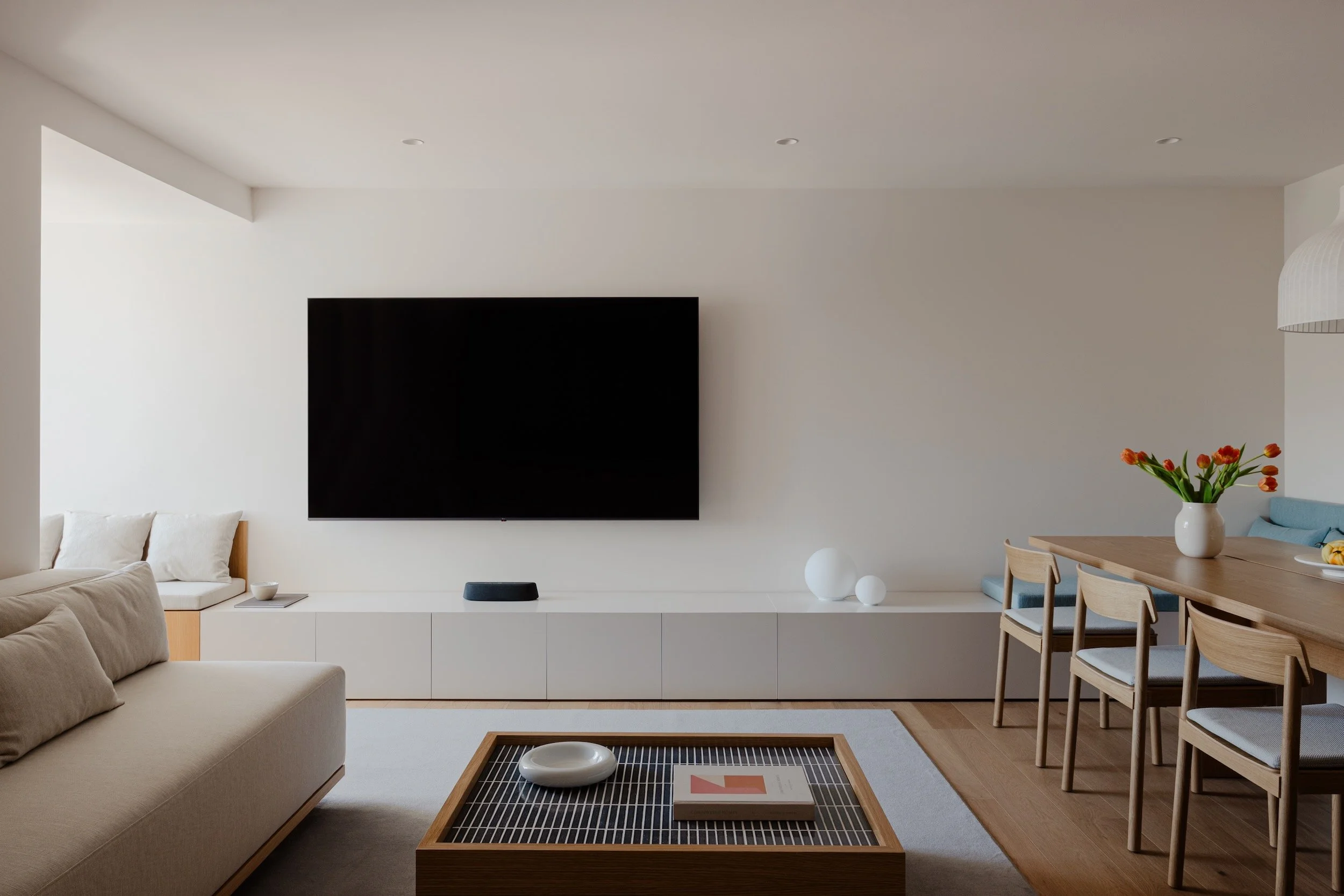 Lola Cwikowski Studio Cascais Residence project with custom Somma Carpintaria sofa in Lauritzon Aqua & coffee table with Marokk Kayo Tokyo tile top; Comforting Homes by Nathalie Deboel; LG TV; custom media unit; CutCut Praia rug.