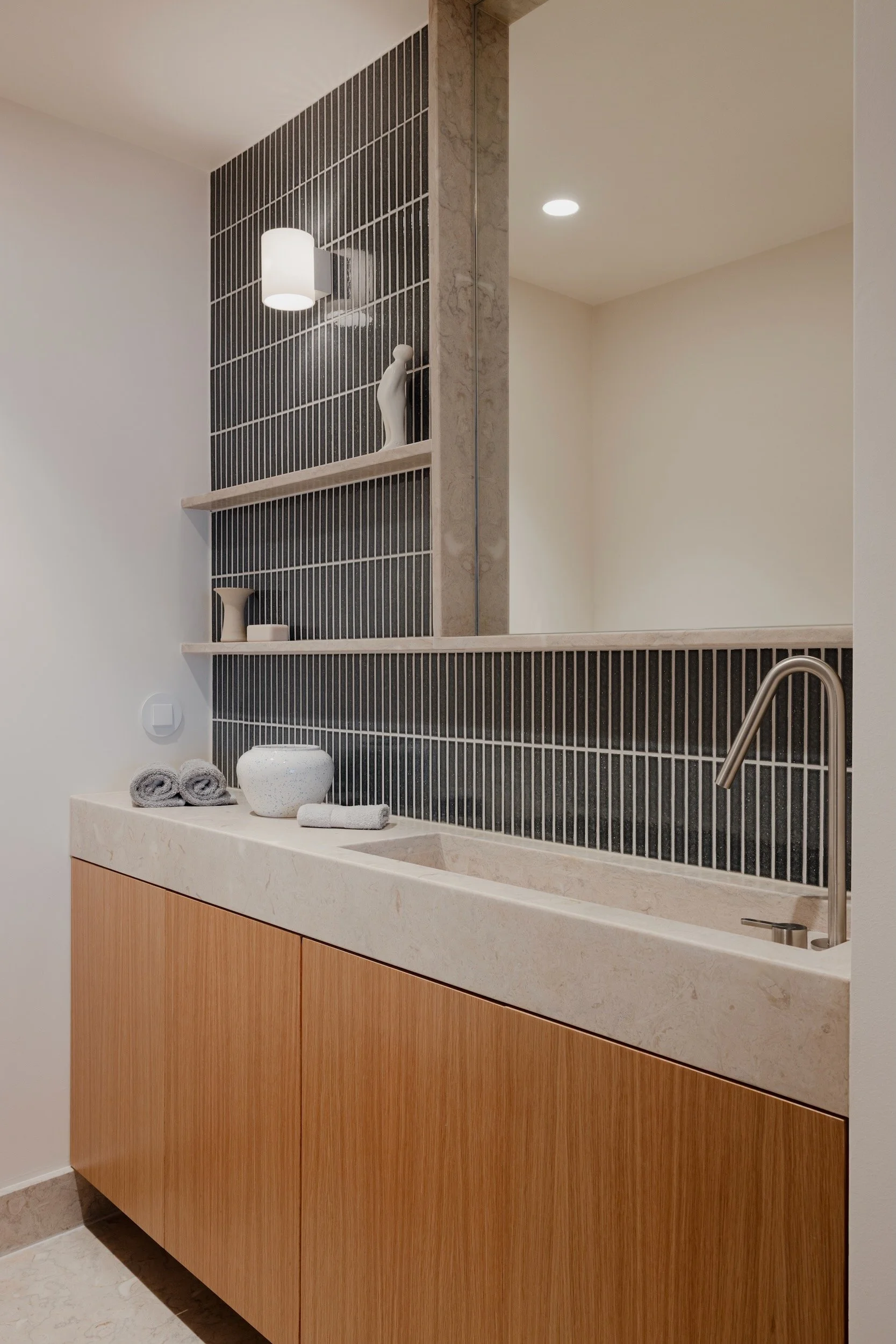 Lola Cwikowski Studio Cascais Residence project with custom Lioz countertop with integrated sink & shelves; oak vanity; Bruma X-Alpha faucet; Marokk Kayo Tokyo tile; Herstal Evoke sconce; ceramics; The Visitor, Guido Deleu.