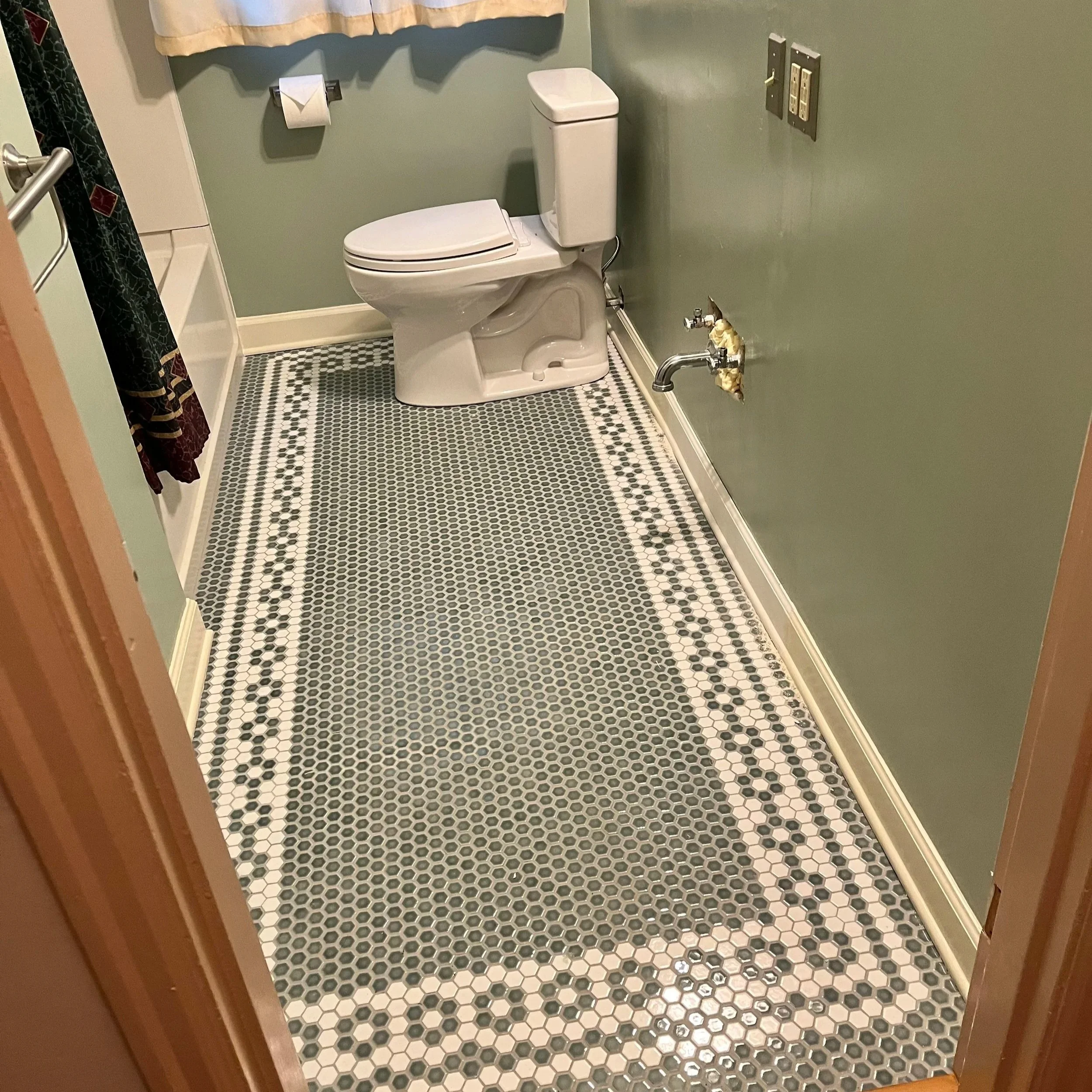 Bathroom tile installation during remodel build phase in Portland OR
