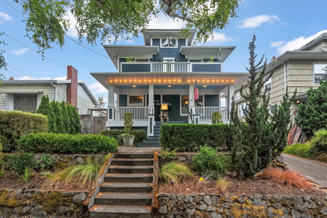 Three-story Portland house with a front porch, repainted in blue with white trim