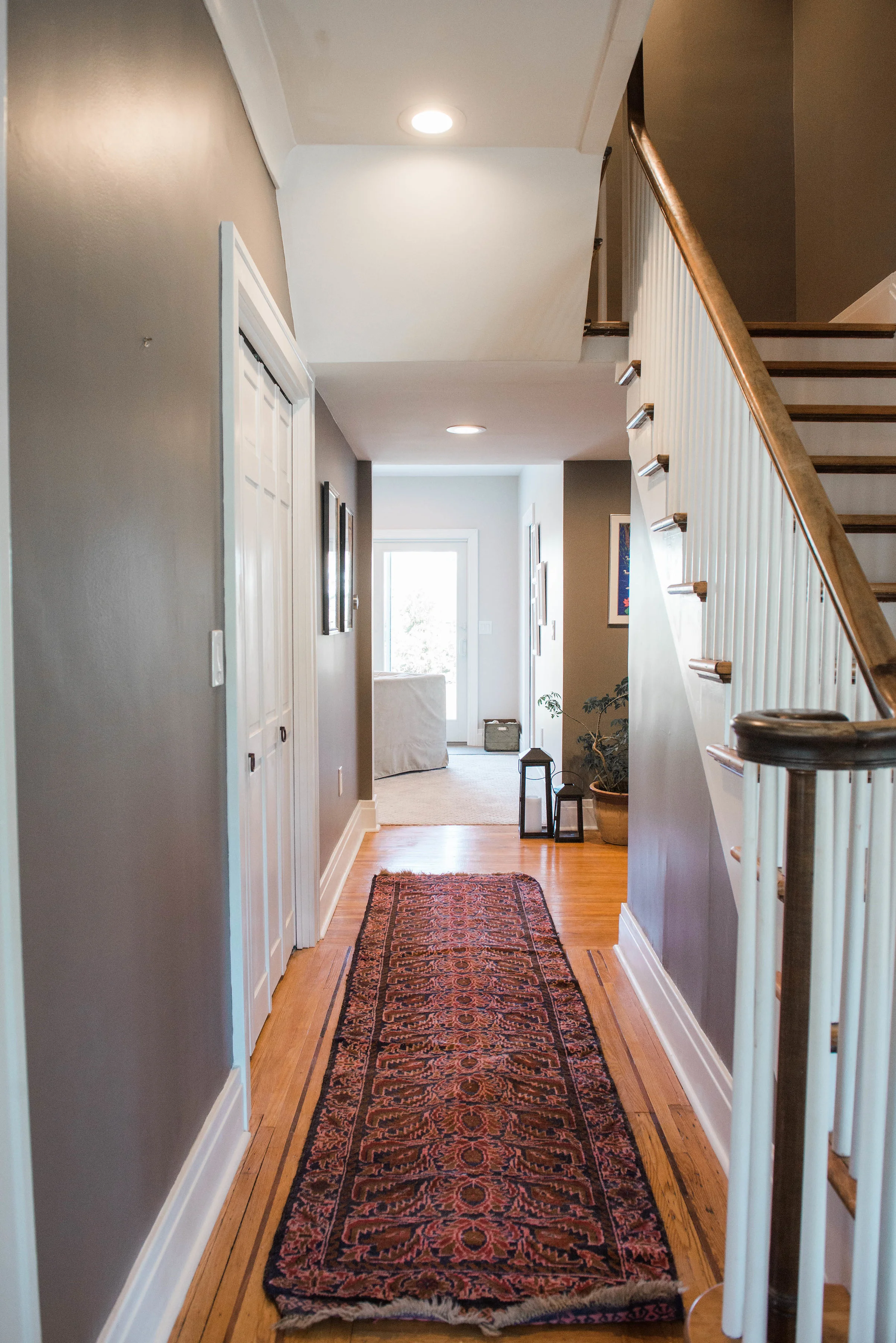 Originally, there was a wall right under the stair landing blocking this view from the front of the home.