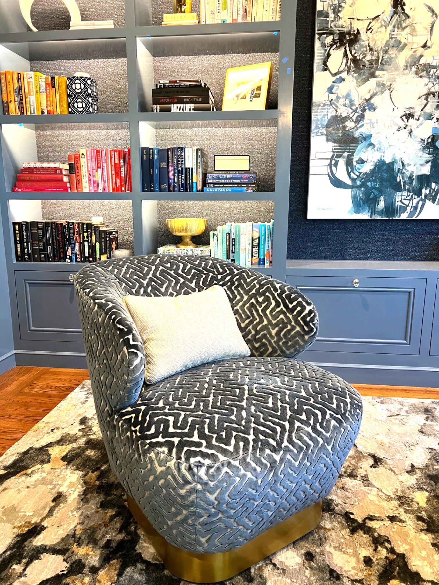  This room is a library by day and a bar by night.  We wanted to bring some drama to this speakeasy, so we went with darker blue hues everywhere except the ceiling.  The marriage of the gold leaf ceiling paper with the chandelier’s illuminated hand-b