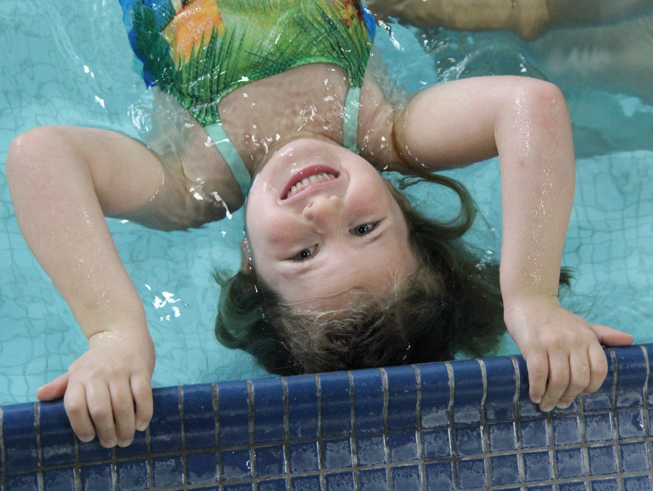 Young smiling girl in pool
