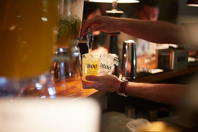 bartender serving 1800 tequila cocktails from beverage dispenser at brand activation event in new york