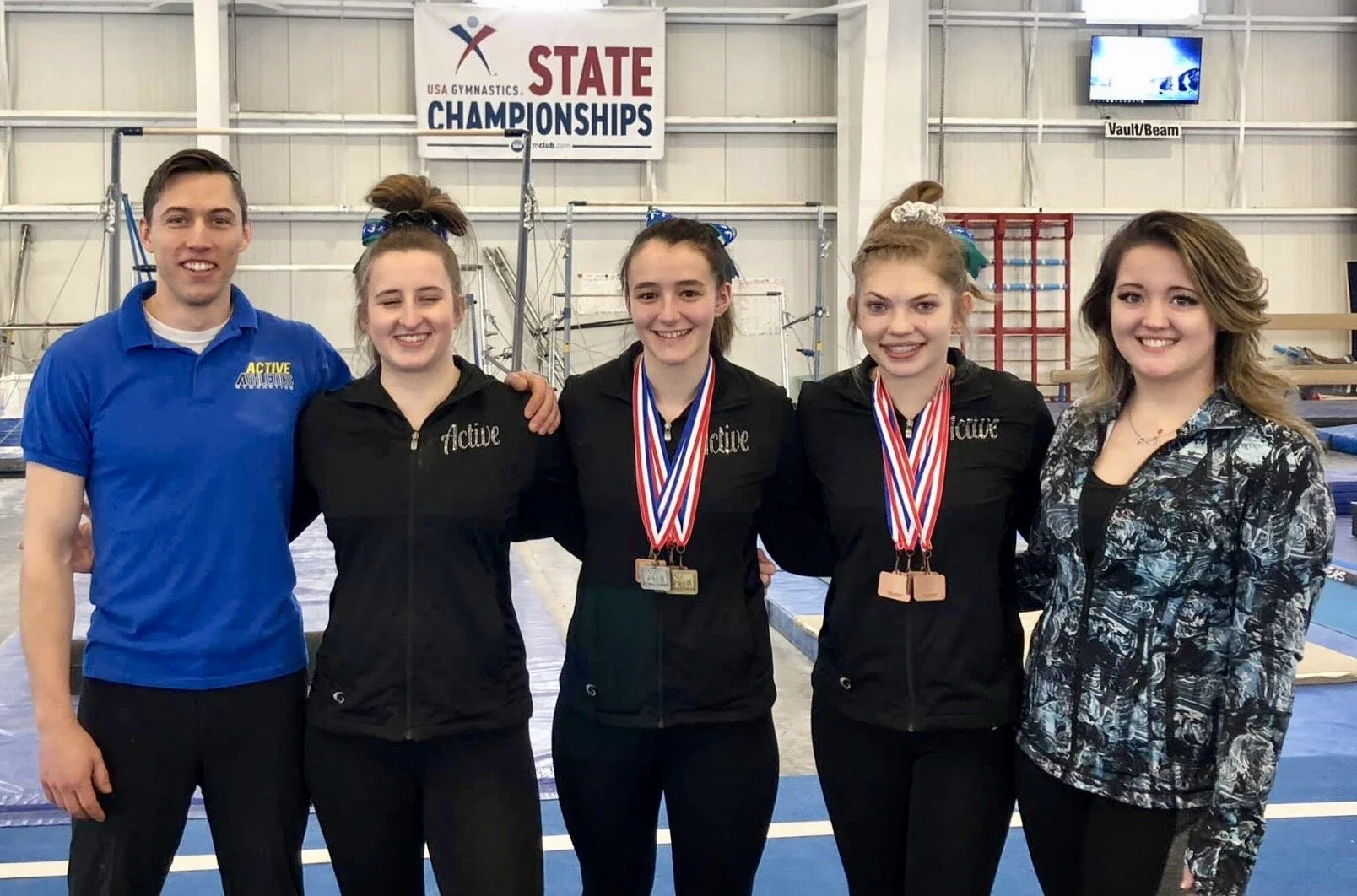  Lauren (center) and team at Colorado State Gymnastics Competition 