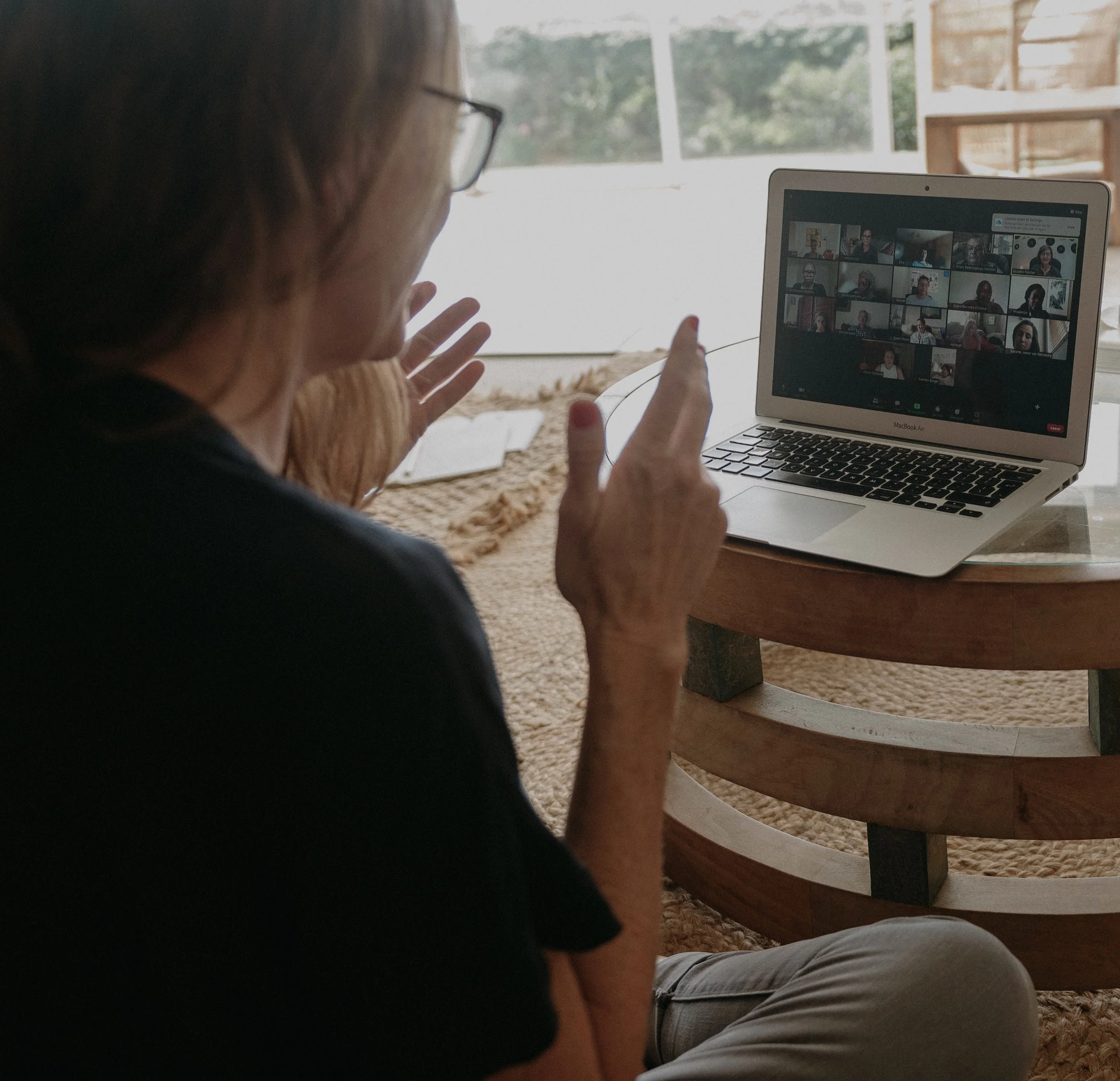 Facilitator leading a team session with a laptop nearby