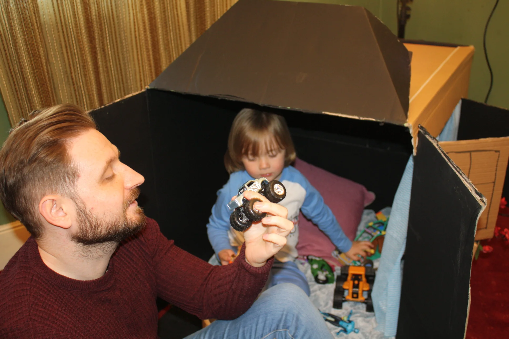 John Sweeney having fun with Caleb's toys