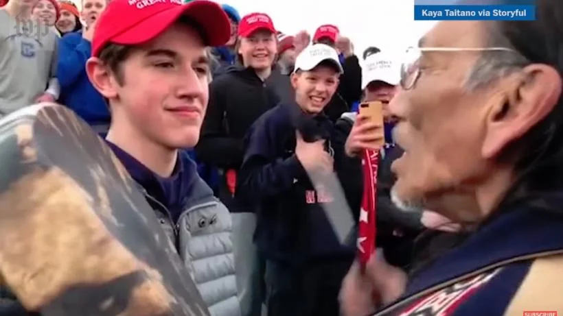The now infamous image of two cultural symbols interacting and spreading media reactions like wildfire.