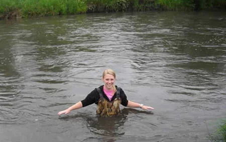 Becca monitoring water in the Little Sioux River while attending a 4 week ecology course at Iowa Lakeside Lab.