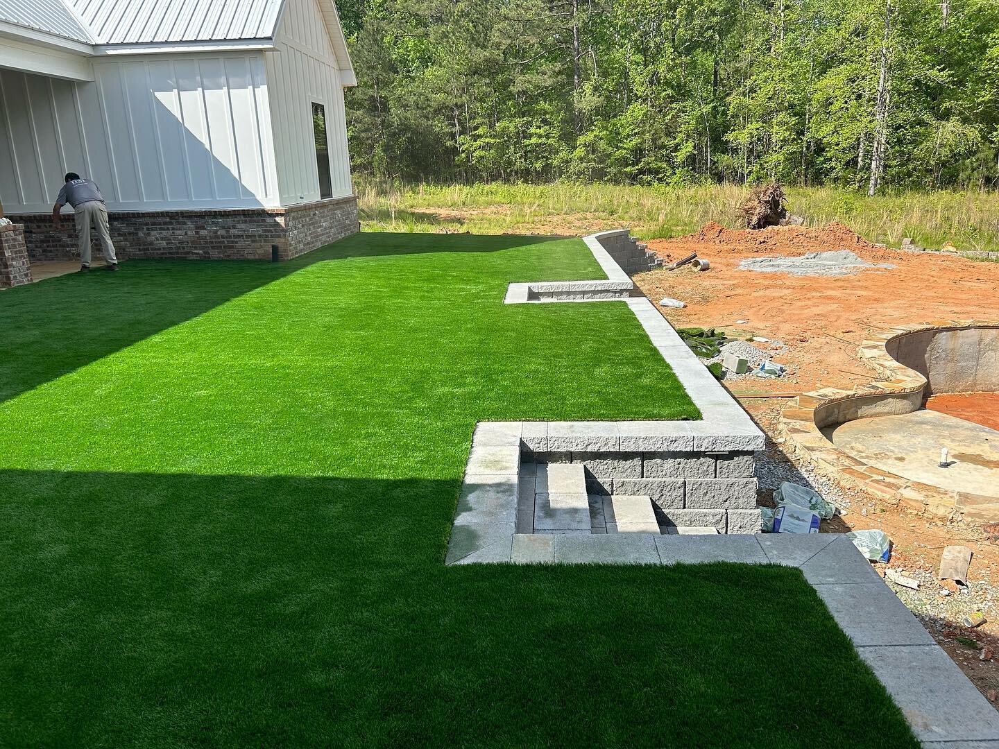 Really cool backyard terrace for this client.  Synthetic turf off the back porch, then SRW wall and steps down to pool.  Landscapes up next! 

@haley.browning @haleybrowningdesigns 

#syntheticturf #retainingwalls #hardscape #landscape