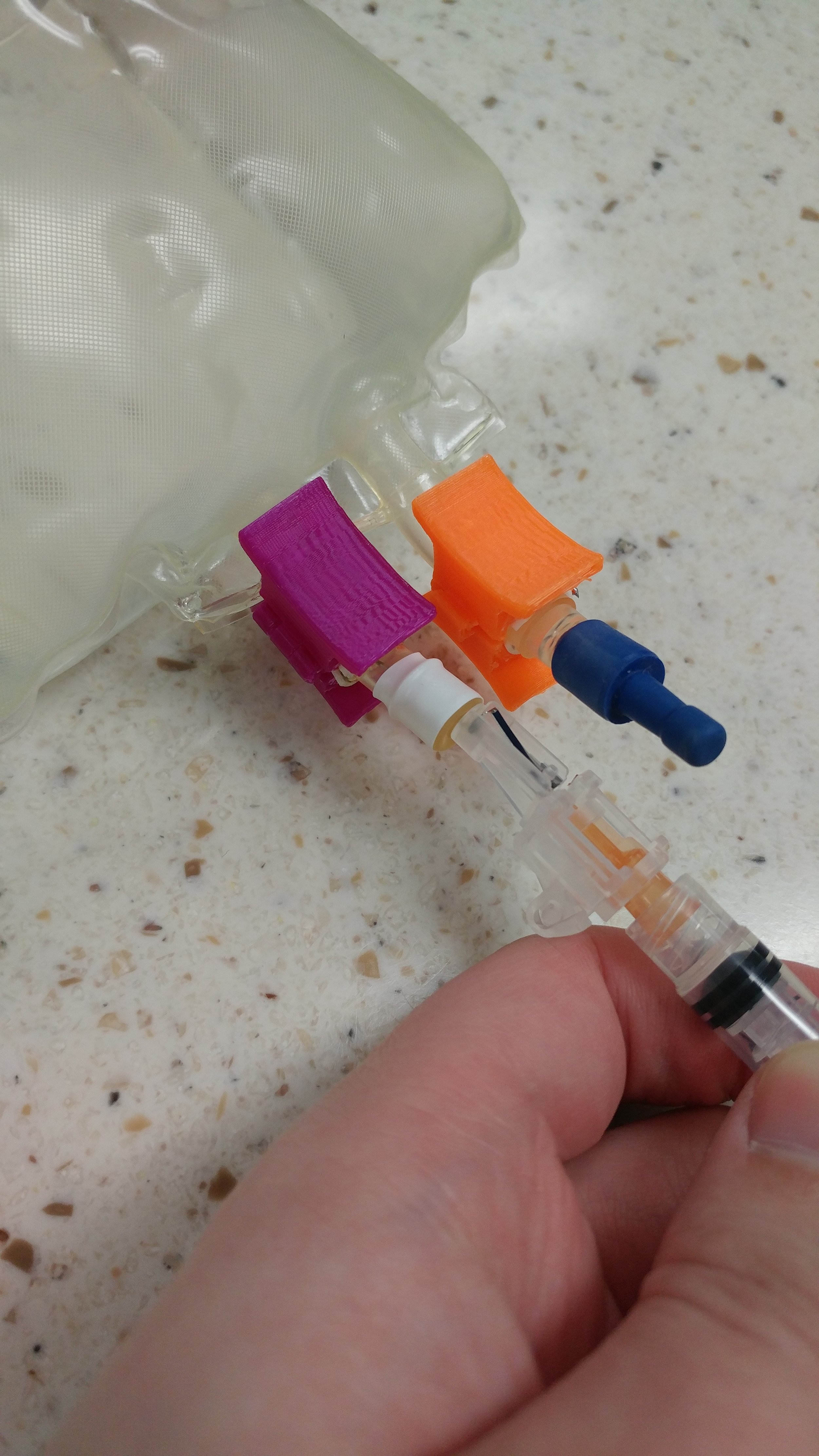 In hospital pharmacy settings, the Spike Assist protects fingers from accidental needle sticks, increasing employee safety.