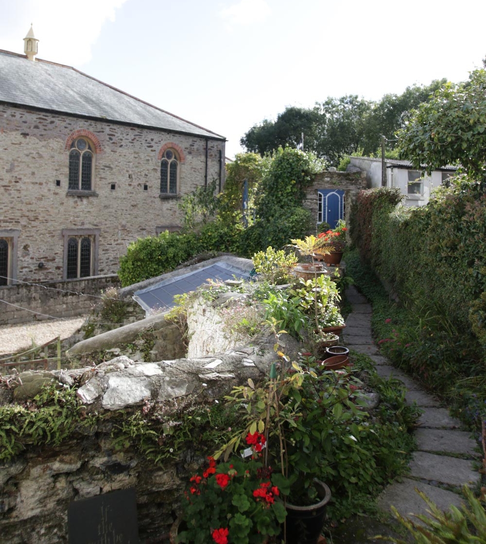   A view of the Fosters’ garden—parts of their stone home may be up to 1,000 years old.   Photo by Dan Saal 