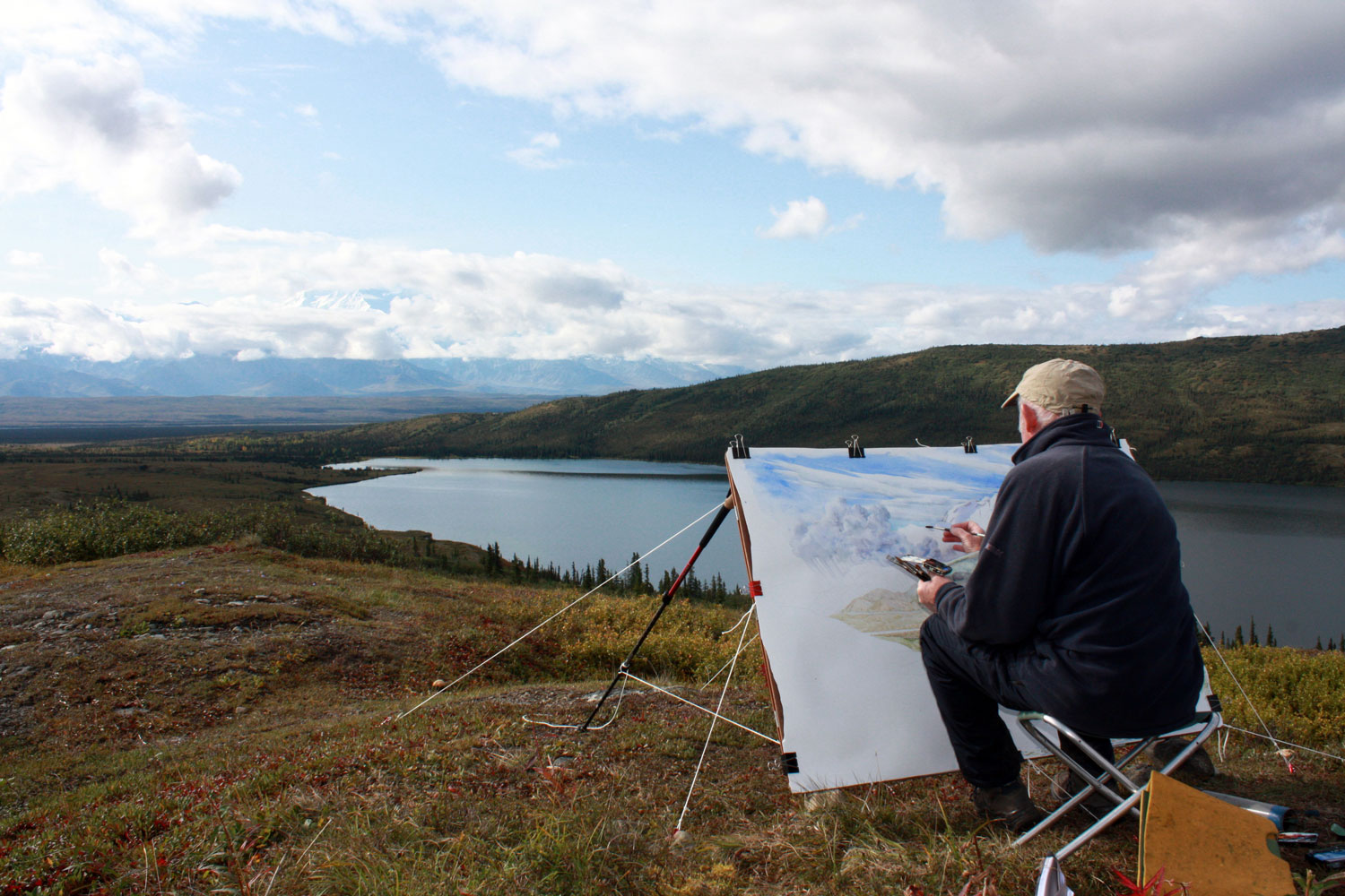  Tony Foster painting in Denali National Park, Alaska, August, 2014. Photo by Becky Williamson. Courtesy Foster Art &amp; Wilderness Foundation.  (Painting is&nbsp; Denali and Wonder Lake Looking South from Ansel Adams Point , 2014. Inventory #2007.1