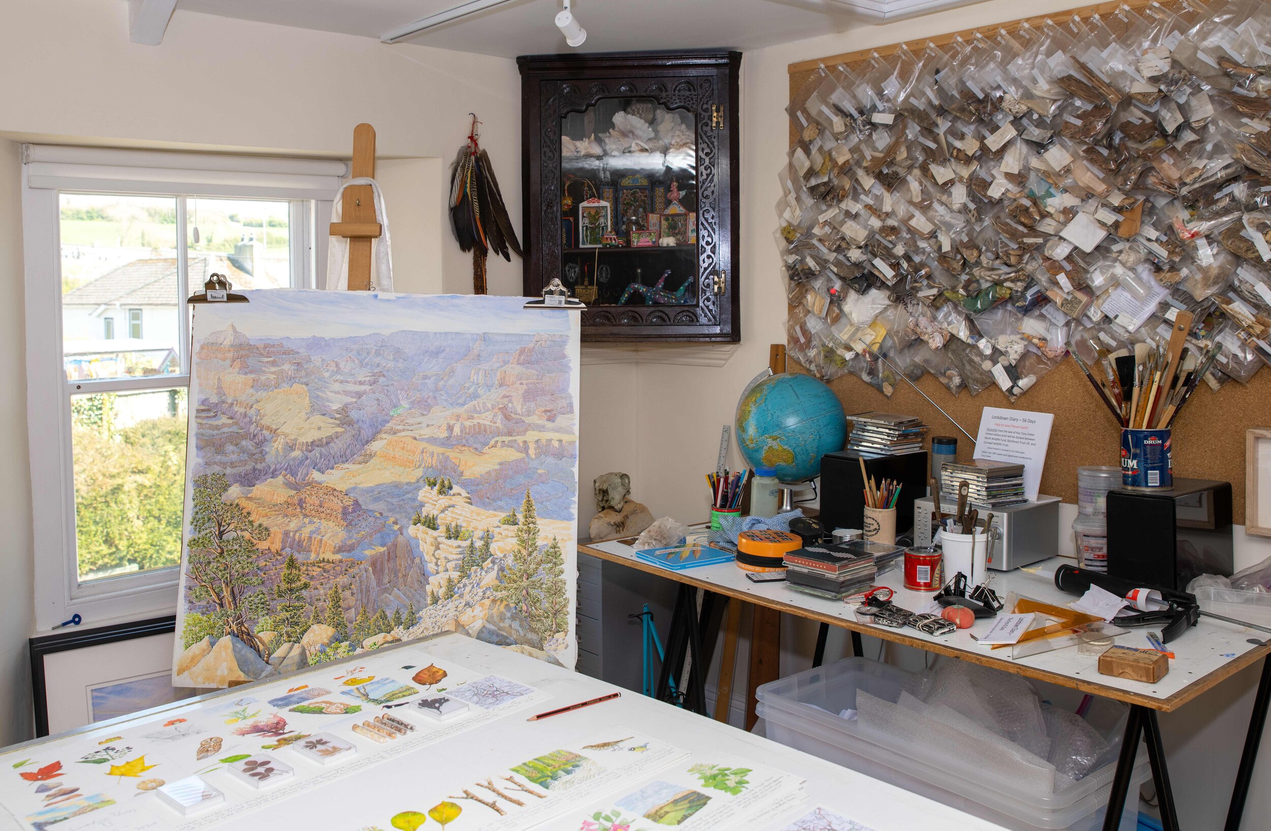   Foster’s studio, with a wall of archived souvenirs to the right, collected over his many expeditions.    Photo by Eileen Howard 