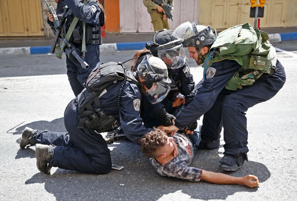Israeli forces arrest a Palestinian youth during clashes between demonstrators and security forces in the city of Hebron in the Israeli-occupied West Bank, on July 28, 2017. Photo: Hazem Bader/AFP/Getty Images