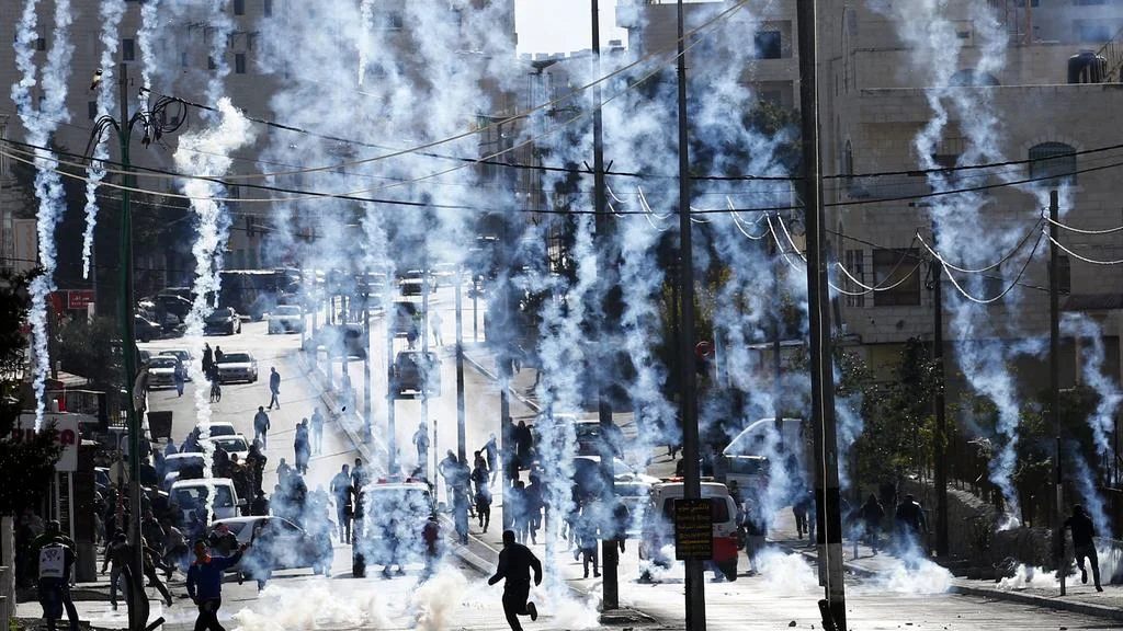 Border Police shoot tear gas at Palestinian protesters in Bethlehem.