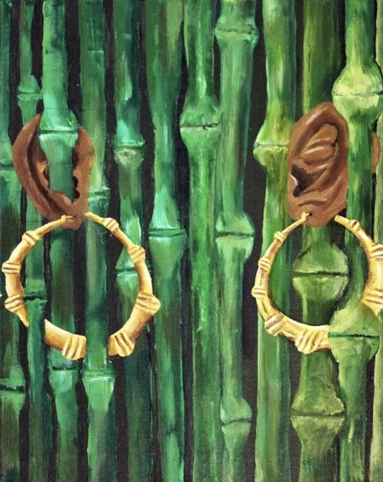BAMBOO EARRINGS This piece addresses cultural appropriation. The warm, vivid greens of the bamboo intertwine with Black ears and the bamboo hoops to represent organic Black culture. The hoops are a staple in the Black community, but Black women have been berated for wearing them. However, when Kim Kardashian or Bella Hadid wear them, they are regarded as high fashion.