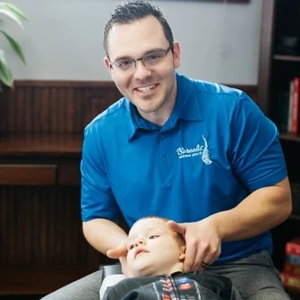 Dr. Klinner adjusting an infant