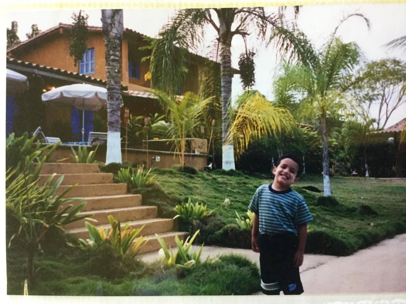 Belardi at the steps of his childhood home in Venezuela. Photo courtesy of Belardi.