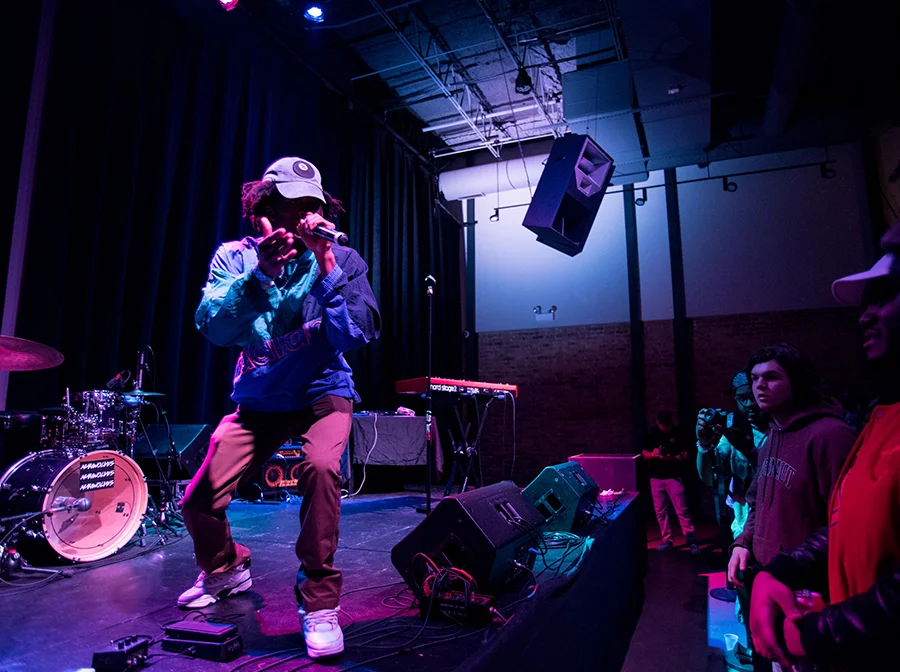 A local artist performs new content for a receptive audience at Chopshop, a restaurant-gone-venue in Wicker Park. Photo by Colin Boyle